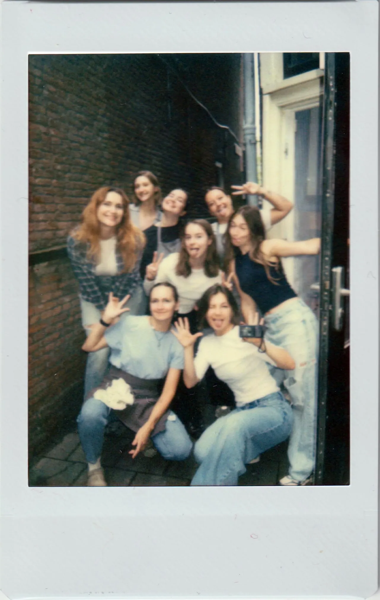 Polaroid of the Blin Queen team in the alley next to the restaurant